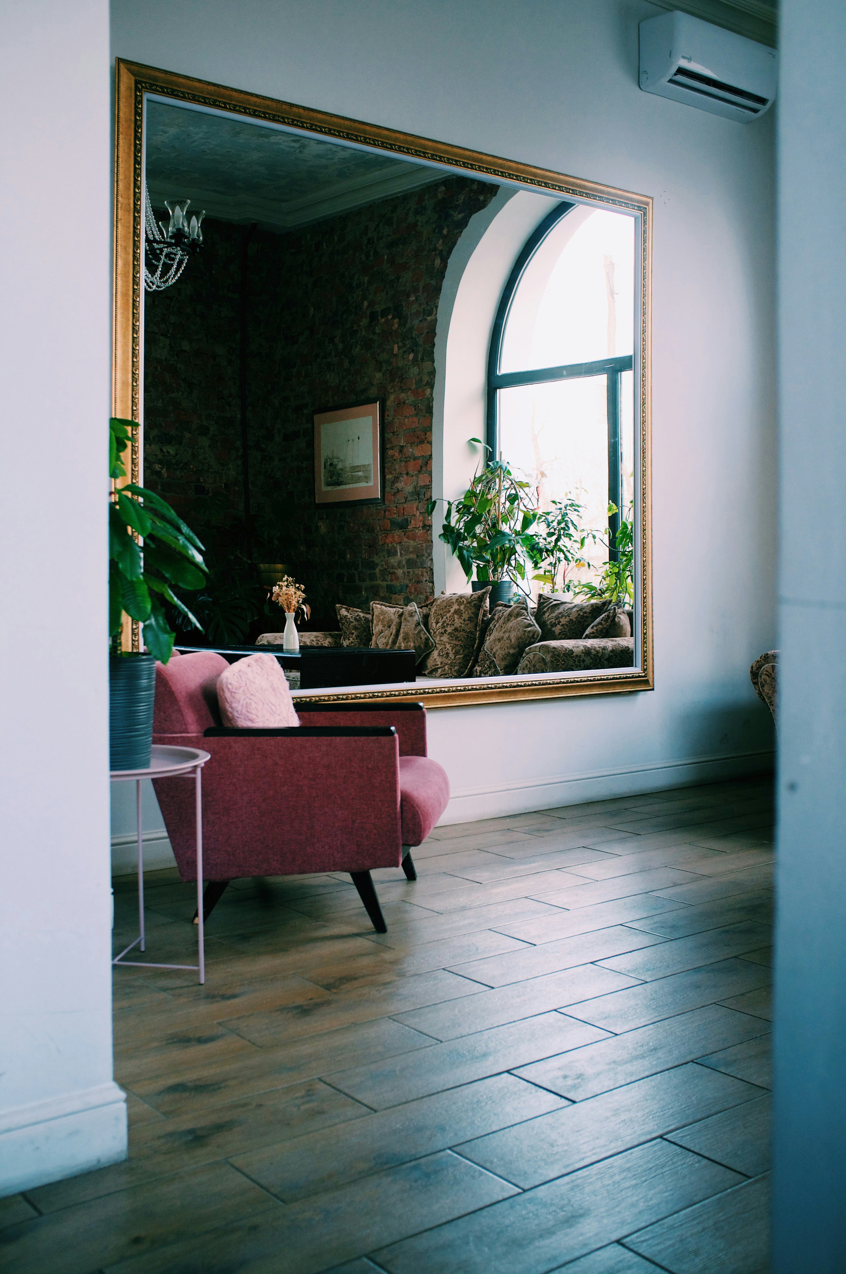 brown wooden framed red padded chair near green potted plant